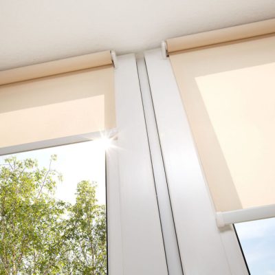 Window with sand coloured roll sun blinds